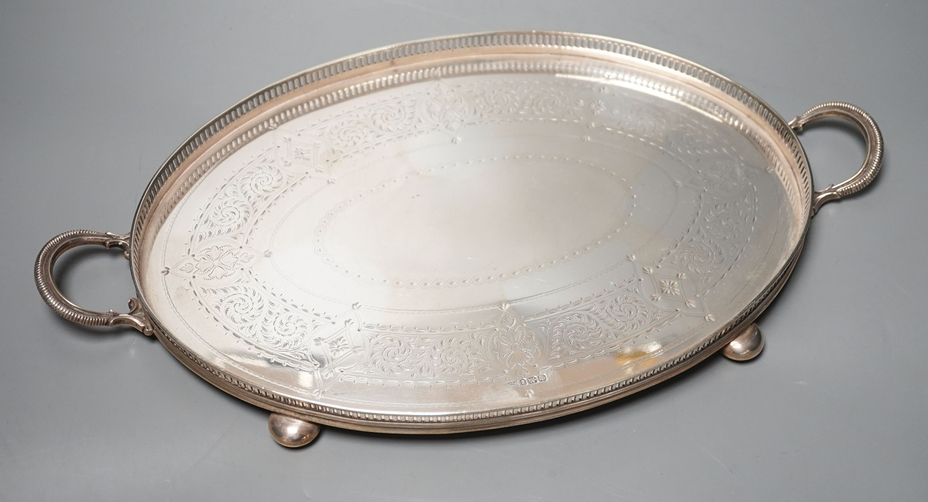 A late Victorian silver oval two handled tea tray, by Walker & Hall, Sheffield, 1898, 45.2cm over handles, 38.5oz.